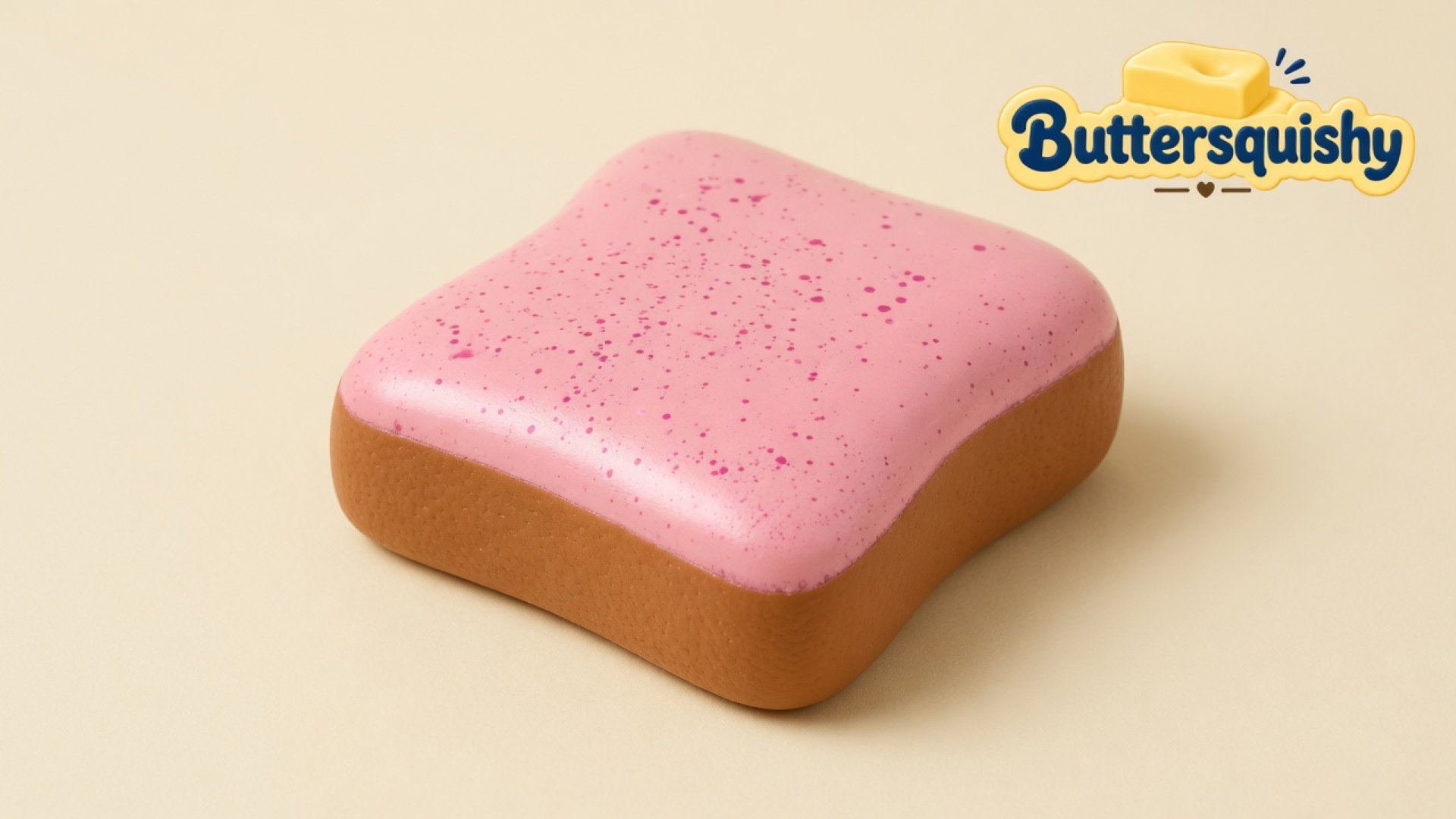 Square Bread Toast Loaf with a strawberry-pink speckled frosting top and caramel-brown crust on a light-yellow cream studio, Buttersquishy logo in the upper right