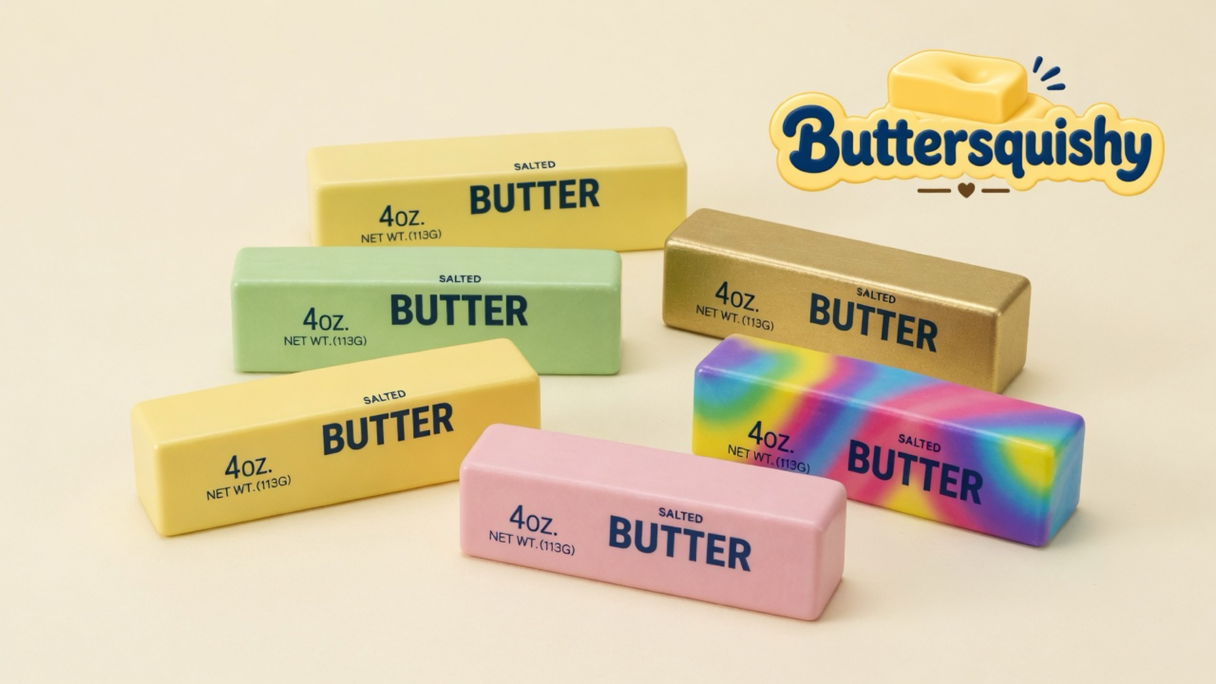 Cream, mint, gold, pink, and rainbow-swirl Mixed Butter Pack sticks with navy SALTED BUTTER print on a light-yellow cream studio, Buttersquishy logo at the upper right