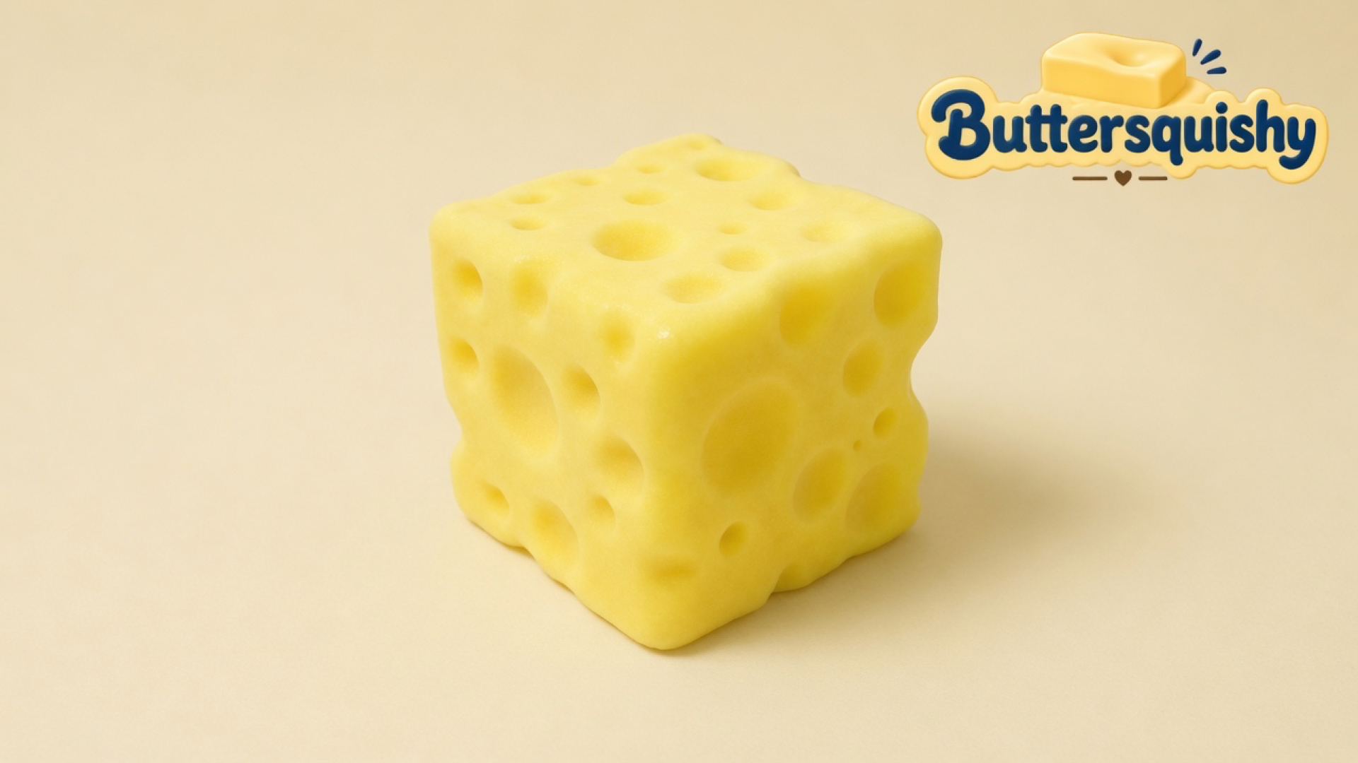 A single lemon-yellow Swiss-hole Cheese Cube Loaf on a cream studio sweep, Buttersquishy logo once at the upper right
