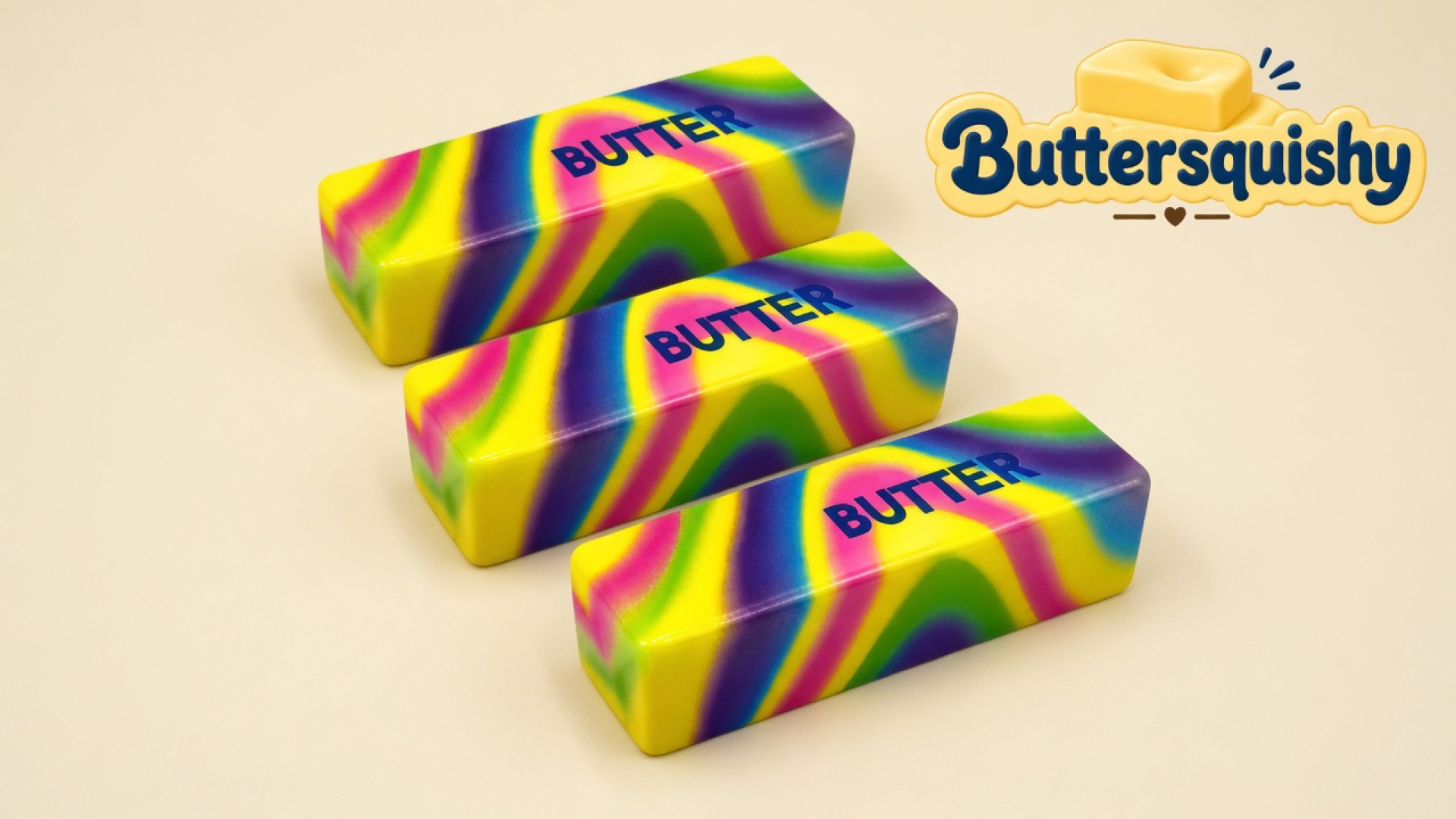 Three rectangular neon-swirl butter sticks printed BUTTER on a light-yellow cream studio, Buttersquishy logo once at the upper right