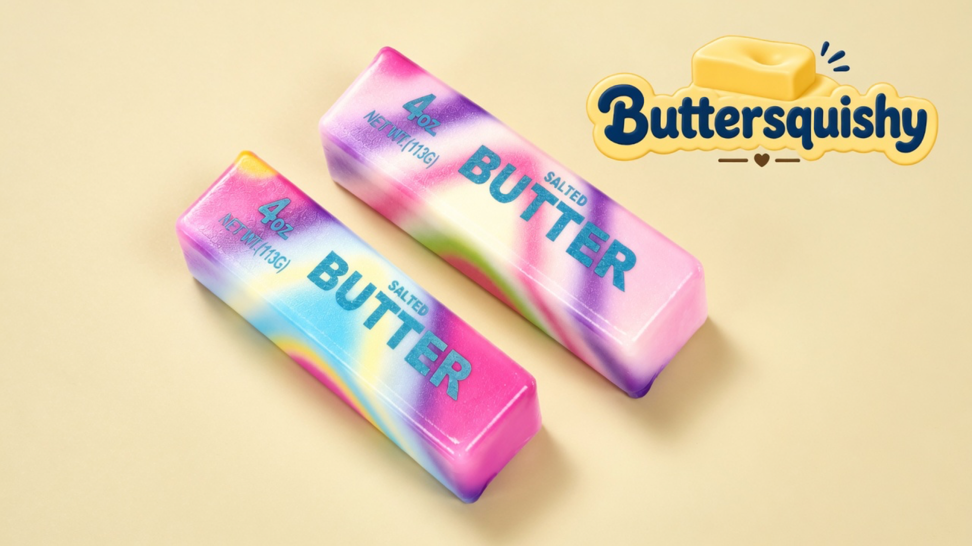 Two pink-purple-blue-yellow tie-dye butter sticks printed 4OZ NET WT.(113G) BUTTER SALTED on a light-yellow cream studio surface, Buttersquishy logo in the upper right