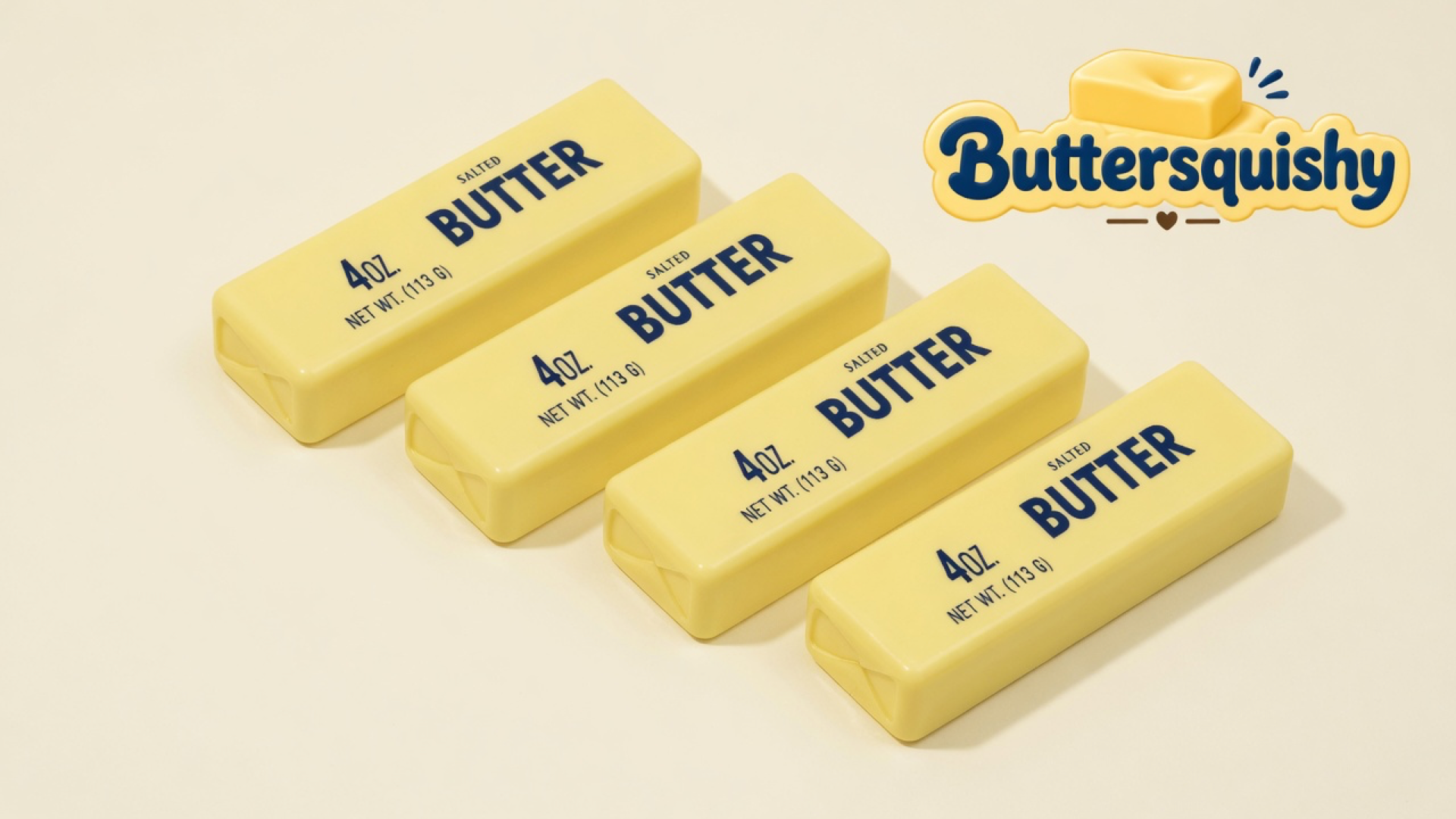 Four matching pale-yellow rectangular butter sticks printed navy SALTED BUTTER and 4 OZ. NET WT. (113 G) on a light-yellow cream studio, Buttersquishy logo at upper right