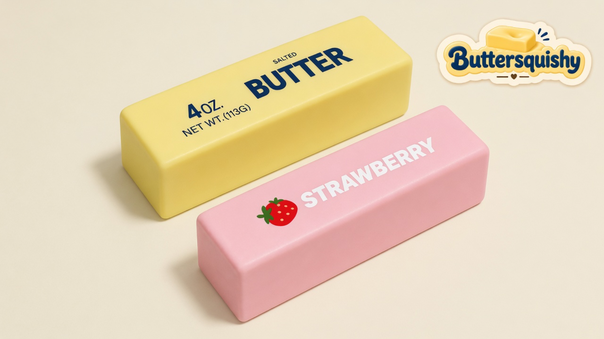 Pale yellow SALTED BUTTER loaf and pink STRAWBERRY loaf on a light-yellow cream studio surface, Buttersquishy logo in the upper right