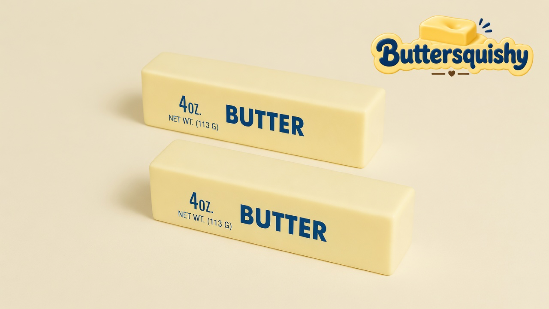 Two pale yellow rectangular Bread Toast Loaf sticks printed navy 4OZ and BUTTER on a light-yellow cream studio table, Buttersquishy logo in the upper right