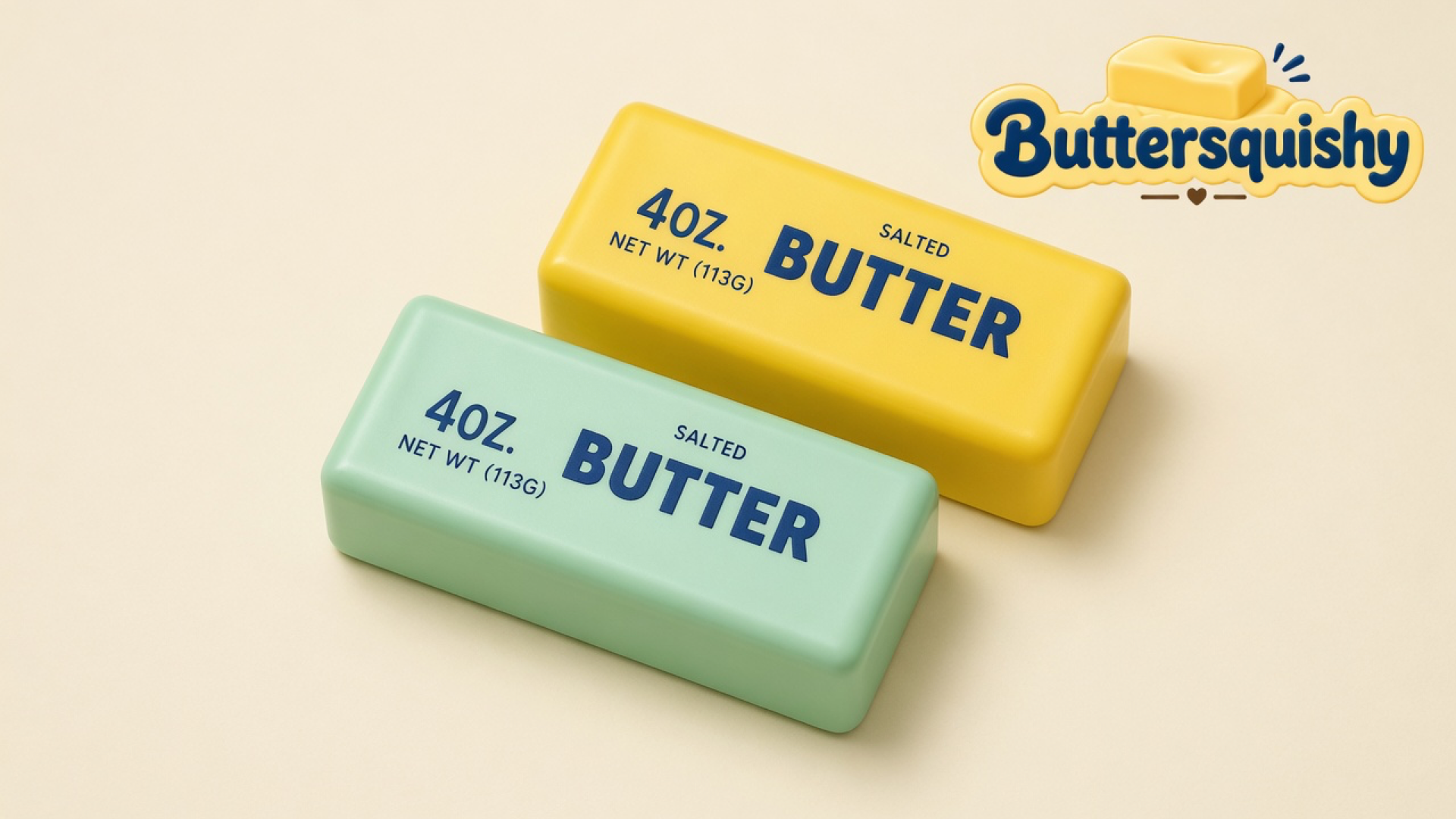 Pale mint-green and lemon-yellow butter-shaped loaves printed SALTED BUTTER on a light-yellow cream studio surface, Buttersquishy logo in the upper right