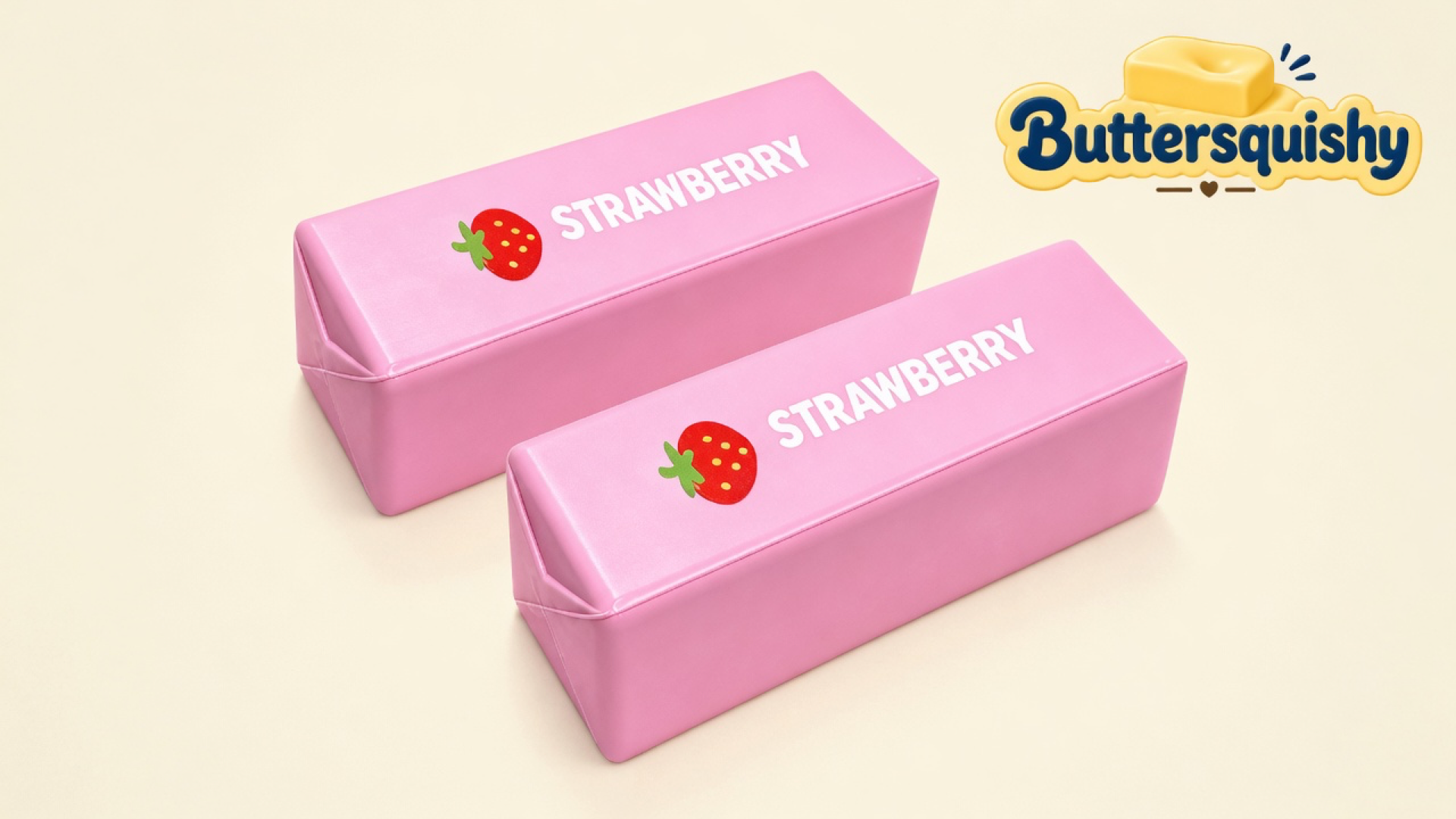 Two matching candy-pink Strawberry Butter Sticks with red berry icons and white STRAWBERRY type on a soft light-yellow cream studio surface, Buttersquishy logo in the upper right