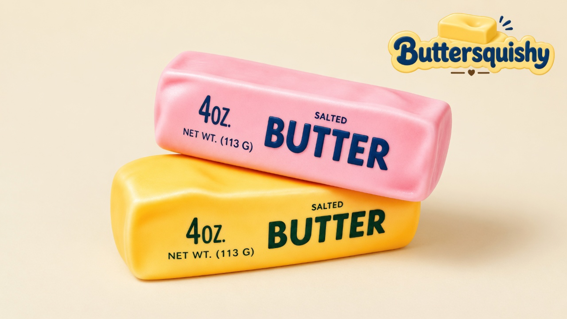 Candy-pink loaf stacked on a yellow-orange loaf, both printed SALTED BUTTER, on a light-yellow cream studio surface with the Buttersquishy logo in the upper right