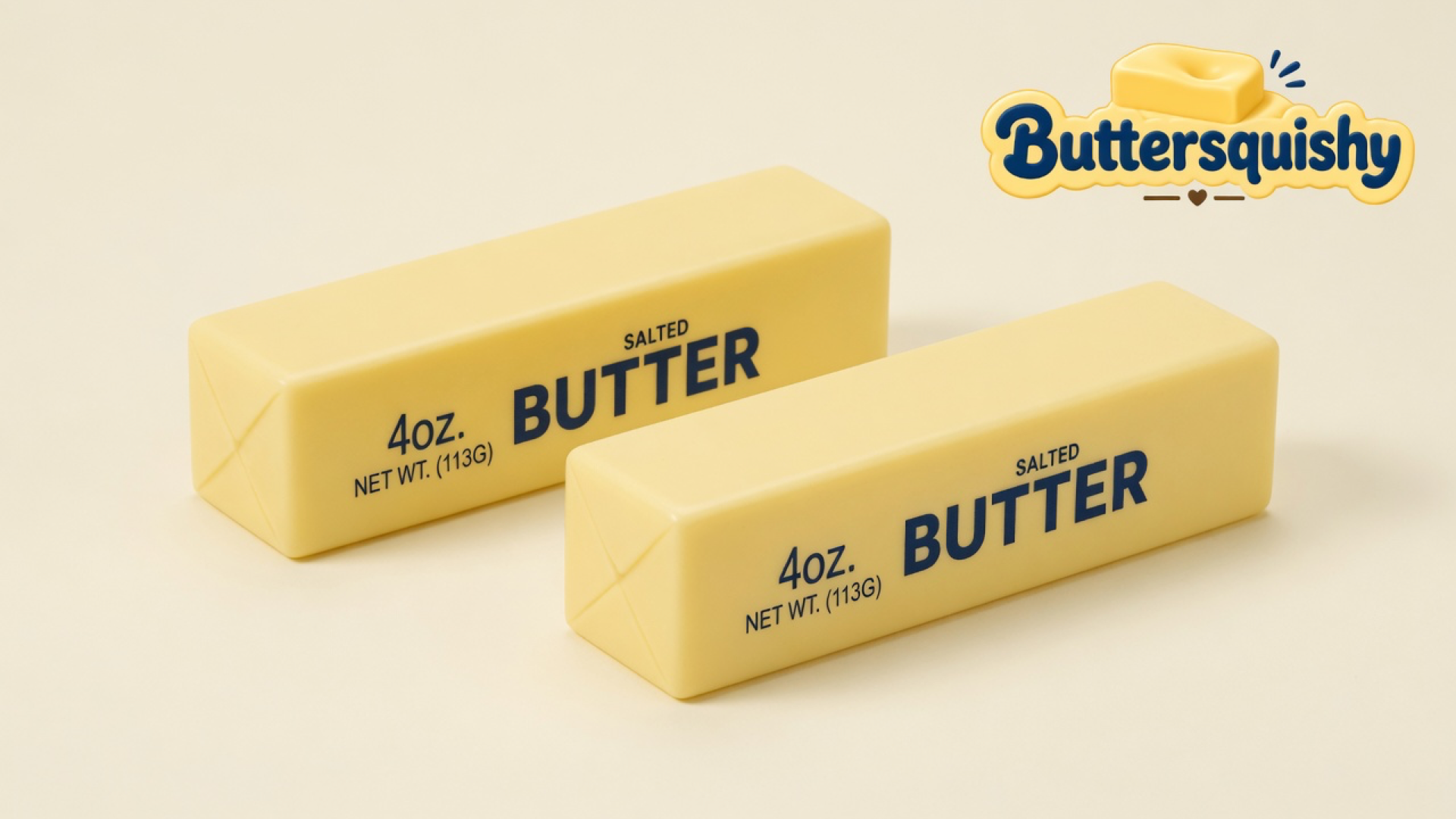 Two pale yellow Classic Gift butter sticks printed SALTED BUTTER and 4OZ. NET WT. (113G) on a light-yellow cream studio, Buttersquishy logo at upper right