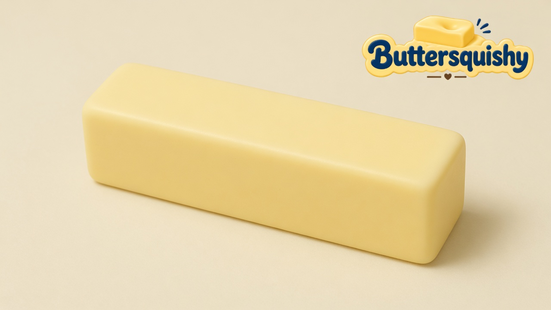 Pale yellow Classic Gift Butter stick on a light-yellow cream studio surface, Buttersquishy logo at upper right