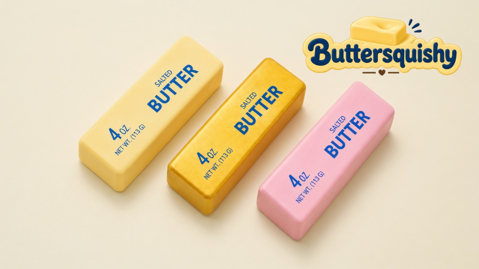 Three cream, gold, and pink Sunset Trio Butter sticks with navy SALTED BUTTER and 4 OZ print on a light-yellow cream studio surface, Buttersquishy logo at upper right