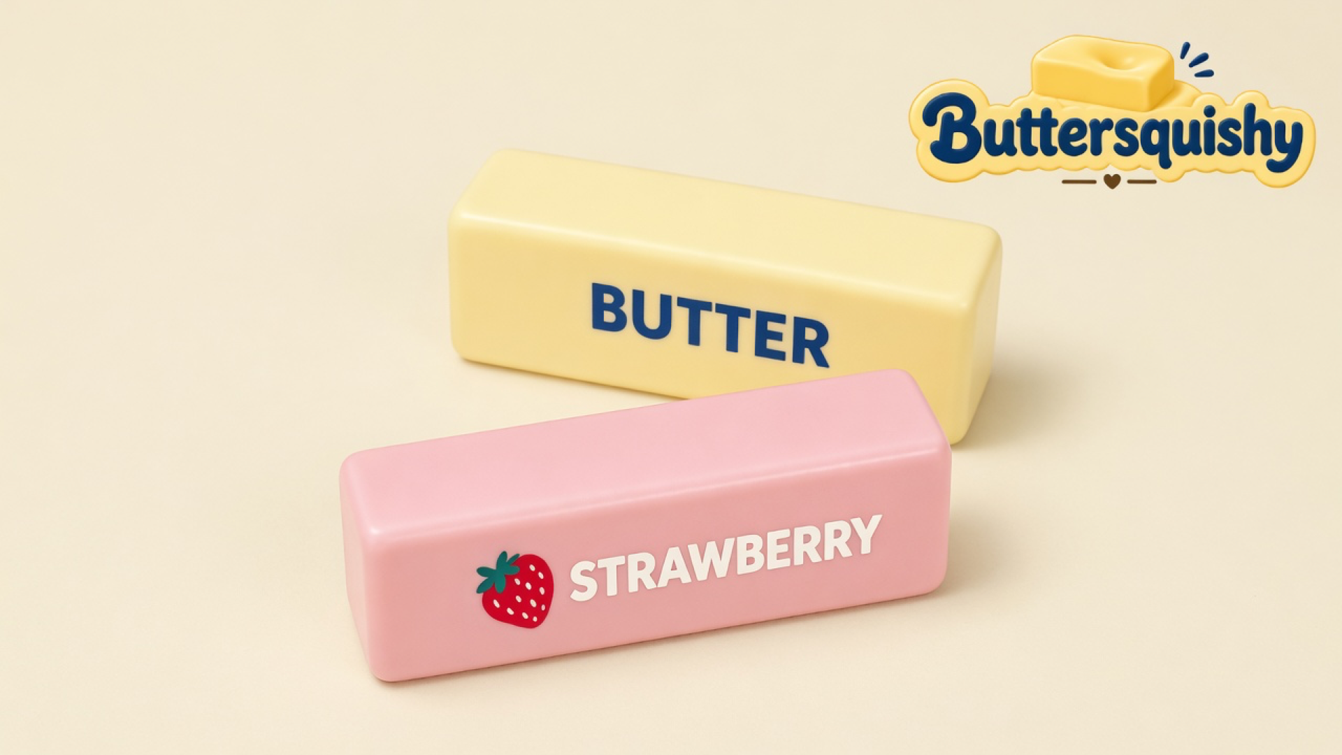 Pale yellow BUTTER loaf and pink STRAWBERRY loaf with a strawberry icon on a light-yellow cream studio surface, Buttersquishy logo at upper right