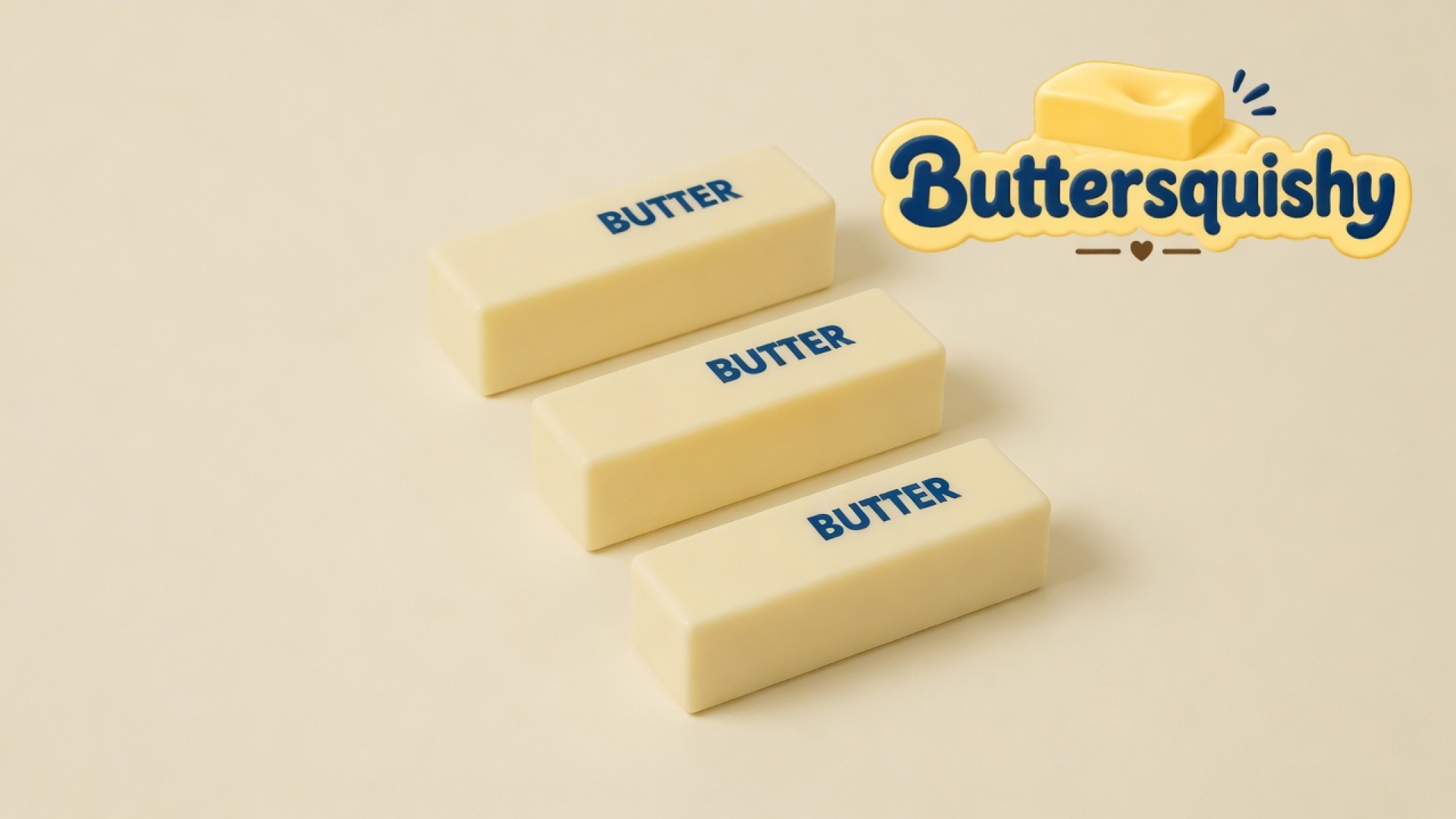 Three pale cream Classic Butter Stick bars printed BUTTER on a light-yellow cream studio surface, Buttersquishy logo at upper right