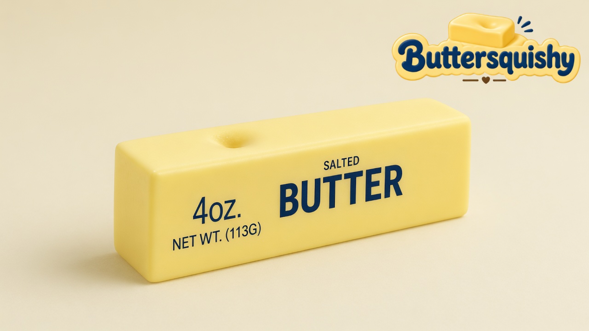 Pale yellow Classic Gift Butter stick printed 4OZ. NET WT. (113G) SALTED BUTTER on a light-yellow cream studio surface, Buttersquishy logo at upper right