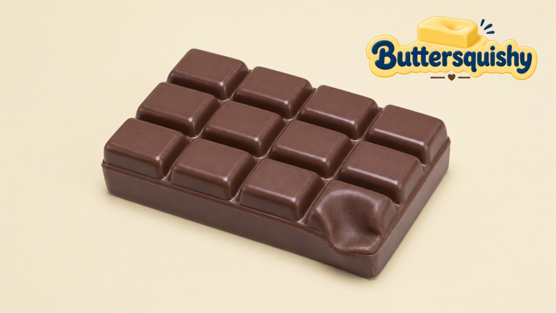 Milk-chocolate twelve-square Chocolate Butter Stick with one pressed square on a light-yellow cream studio, Buttersquishy logo in the upper right