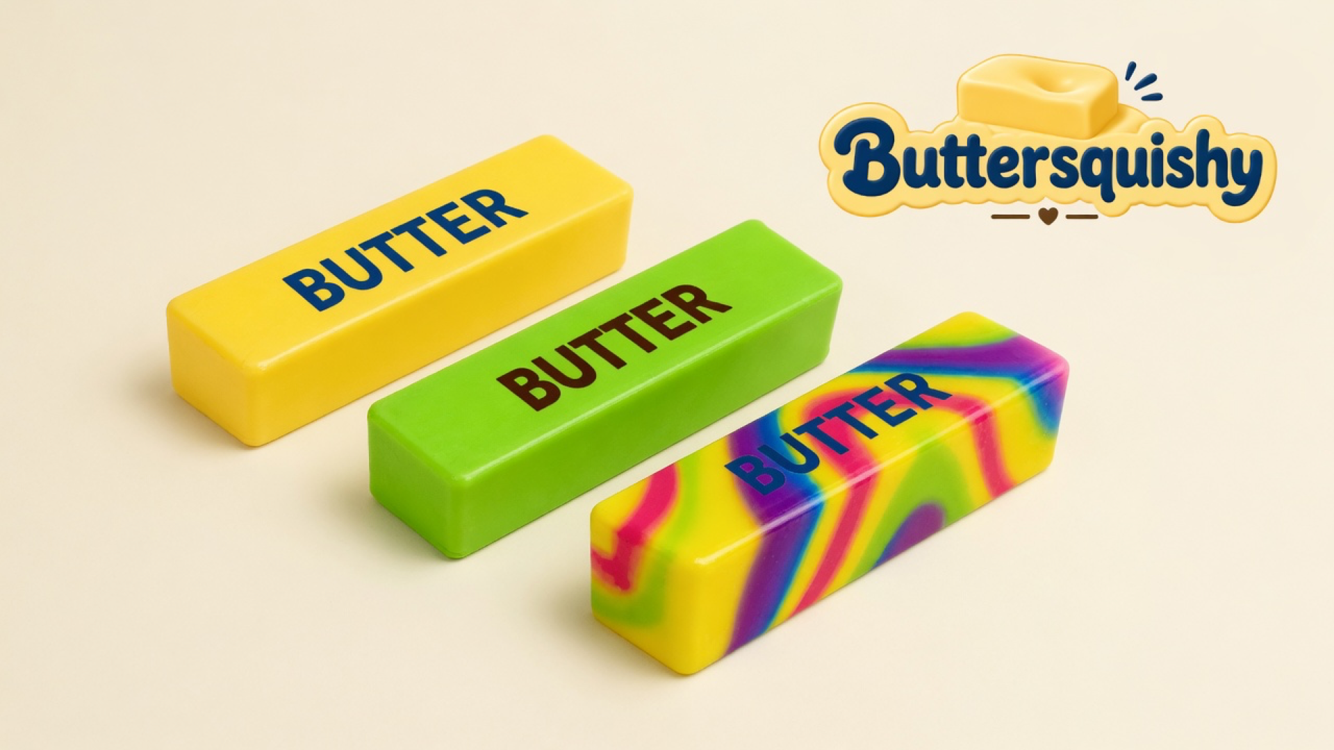 Three Swirl Mix Butter sticks — yellow, lime, and rainbow marble loaves printed BUTTER — on a light-yellow cream studio surface, Buttersquishy logo in the upper right