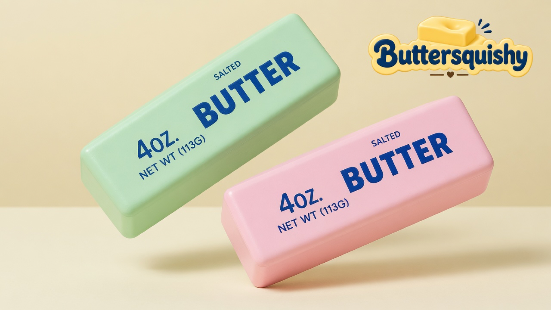 Pale mint-green and pastel-pink SALTED BUTTER sticks on a light-yellow cream studio table, Buttersquishy logo in the upper right