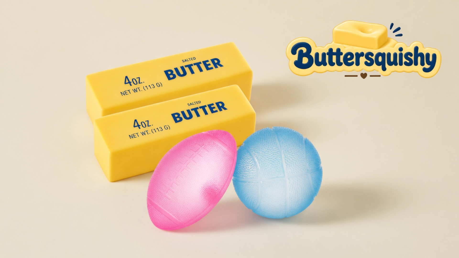Two yellow salted-butter sticks stacked above a pink football and a pale-blue basketball on a light-yellow cream studio surface, Buttersquishy logo in the upper right