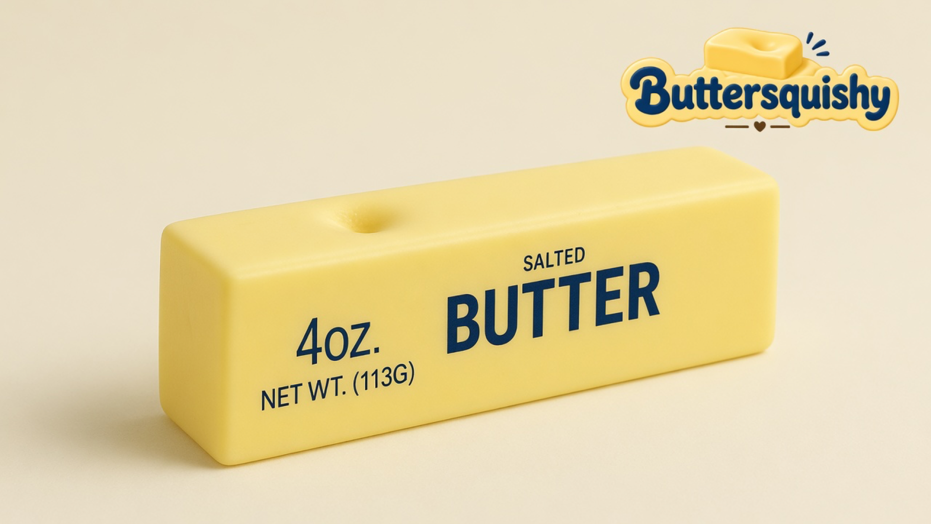 Pale yellow SALTED BUTTER stick with a top dimple on a light-yellow cream studio, Buttersquishy logo in the upper right