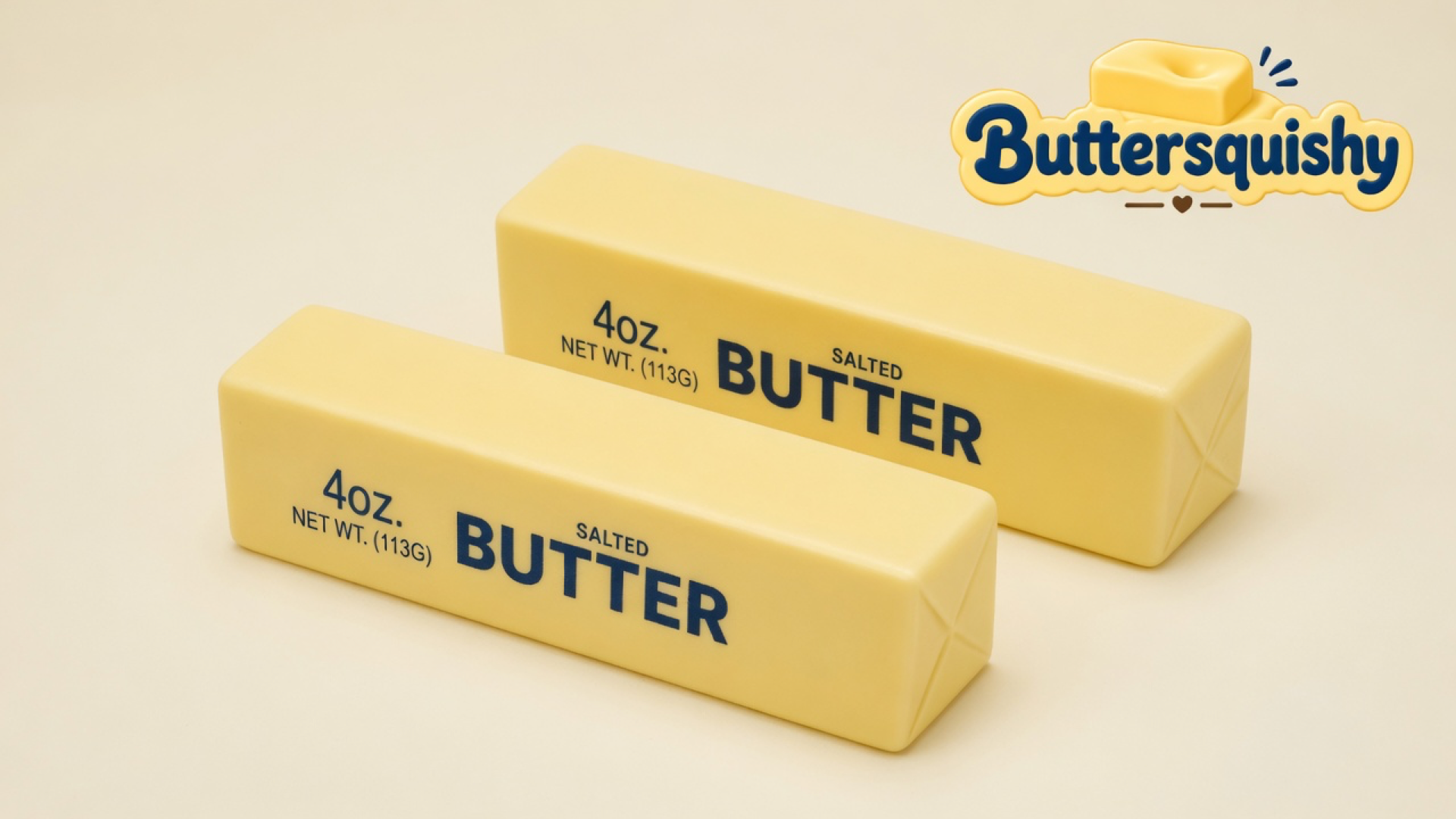 Two pale-yellow Classic Gift Butter sticks printed 4OZ NET WT. (113G) BUTTER SALTED on a light-yellow cream studio, Buttersquishy logo in the upper right