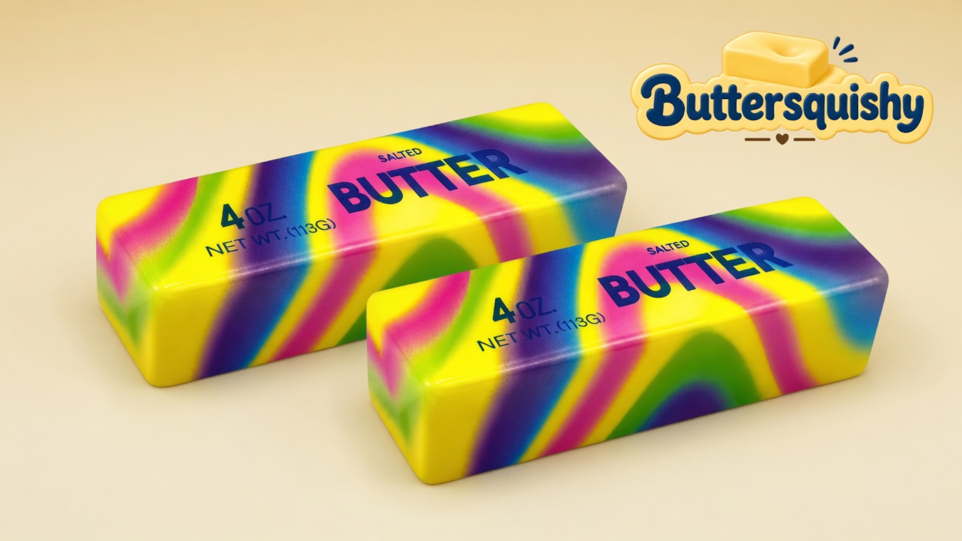 Two matching neon-rainbow butter sticks printed SALTED BUTTER and 4 OZ. on a light-yellow cream studio surface, Buttersquishy logo in the upper right