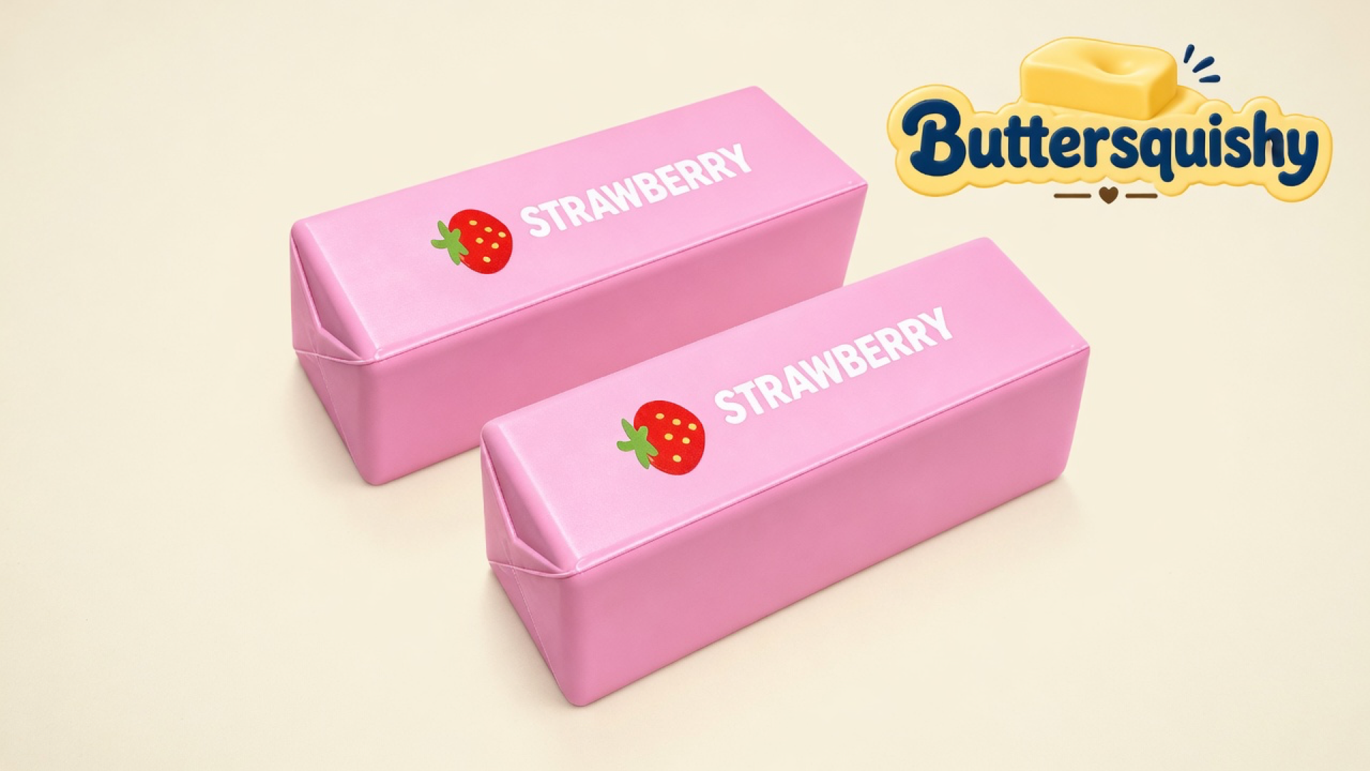Two matching candy-pink Strawberry Butter Stick loaves printed STRAWBERRY with a berry icon, on a light-yellow cream studio, Buttersquishy logo in the upper right