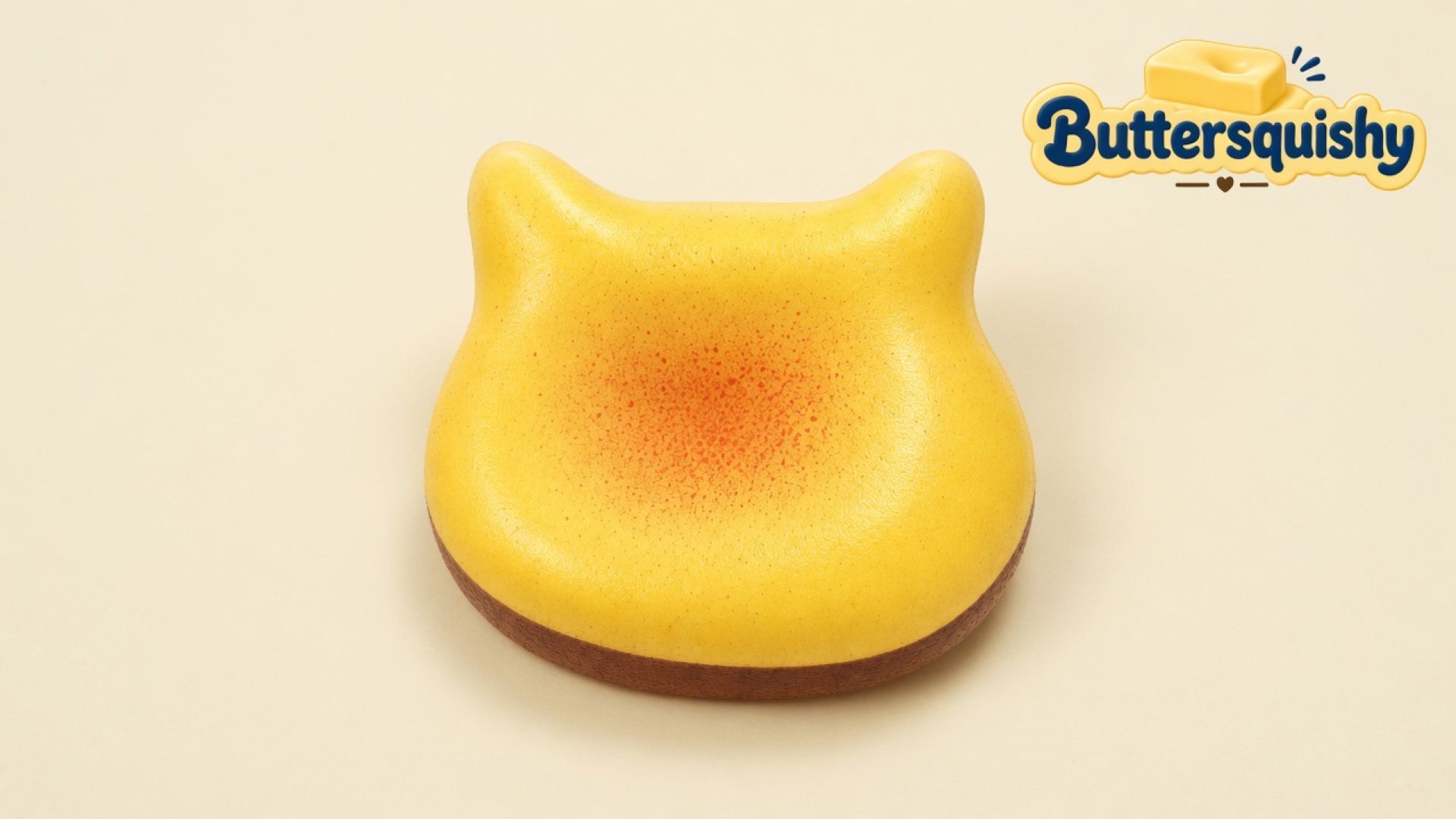 Yellow toasted Bread Toast Loaf with an orange-speckled face and brown crust on a light-yellow cream studio, Buttersquishy logo at upper right