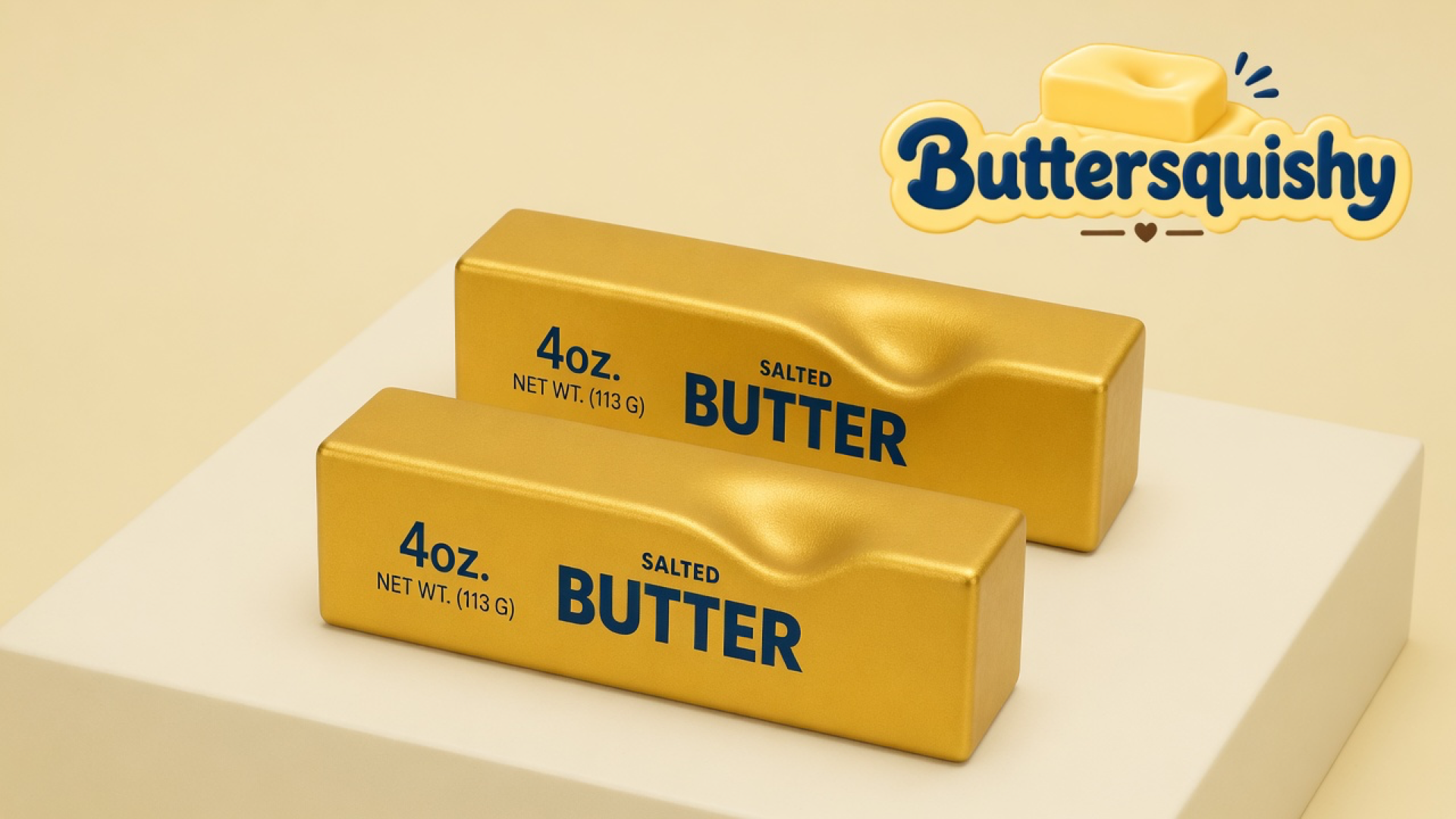 Two gold-foil Golden Butter Stick loaves printed SALTED BUTTER and 4oz on a light-yellow cream studio block, Buttersquishy logo in the upper right