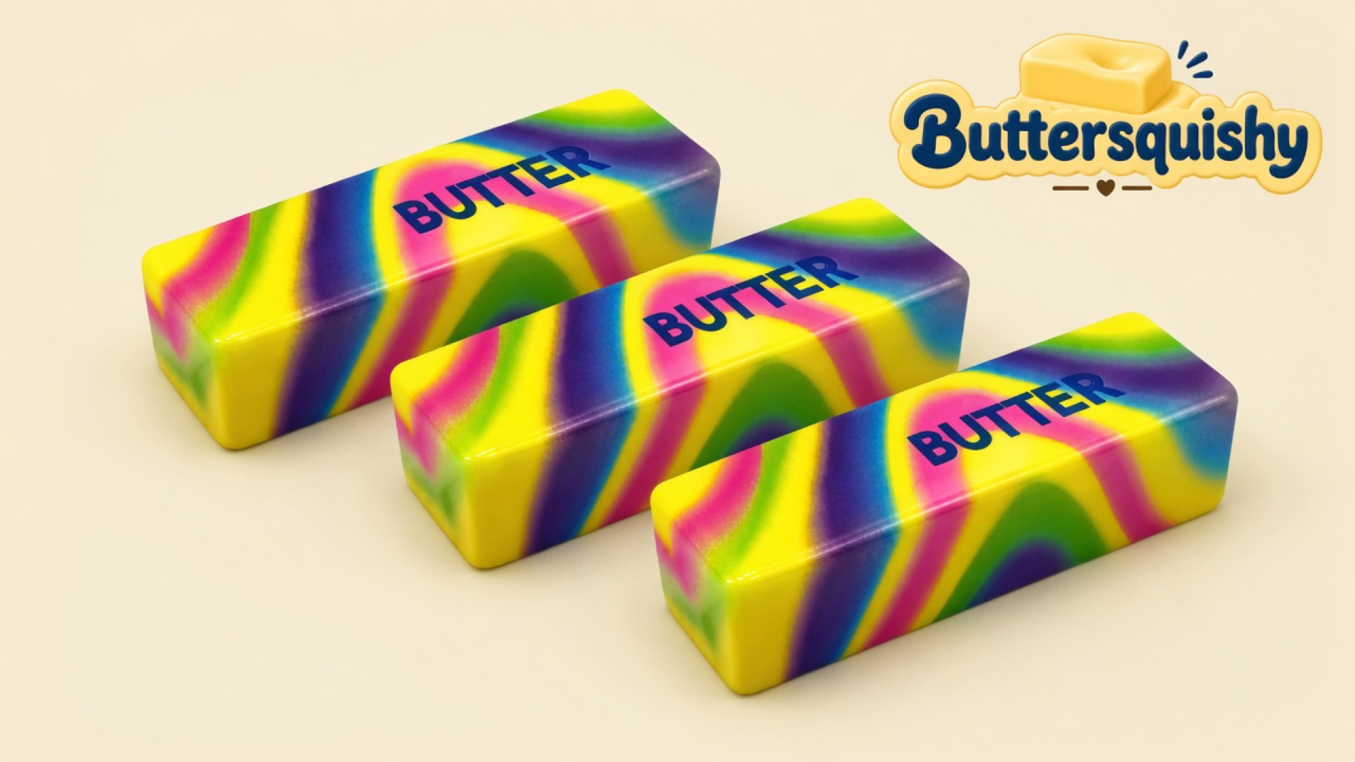 Three matching neon-swirl butter sticks printed BUTTER on a light-yellow cream studio surface, Buttersquishy logo in the upper right