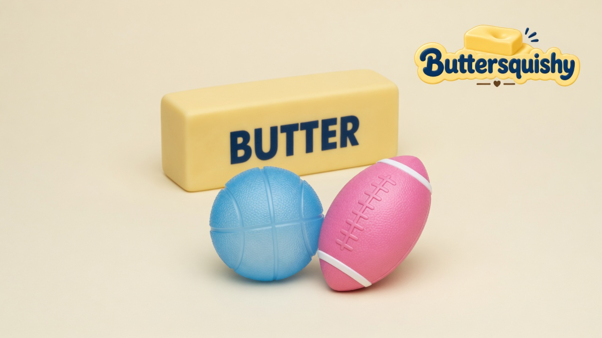 Yellow BUTTER loaf, light-blue basketball, and pink football toys on a soft light-yellow cream studio surface, Buttersquishy logo in the upper right
