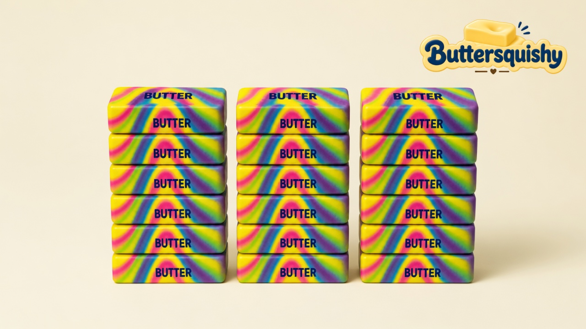 Eighteen Neon Swirl Butter sticks in three stacks of six, neon yellow-magenta-cyan-purple swirls with navy BUTTER print, on a light-yellow cream studio surface, Buttersquishy logo in the upper right