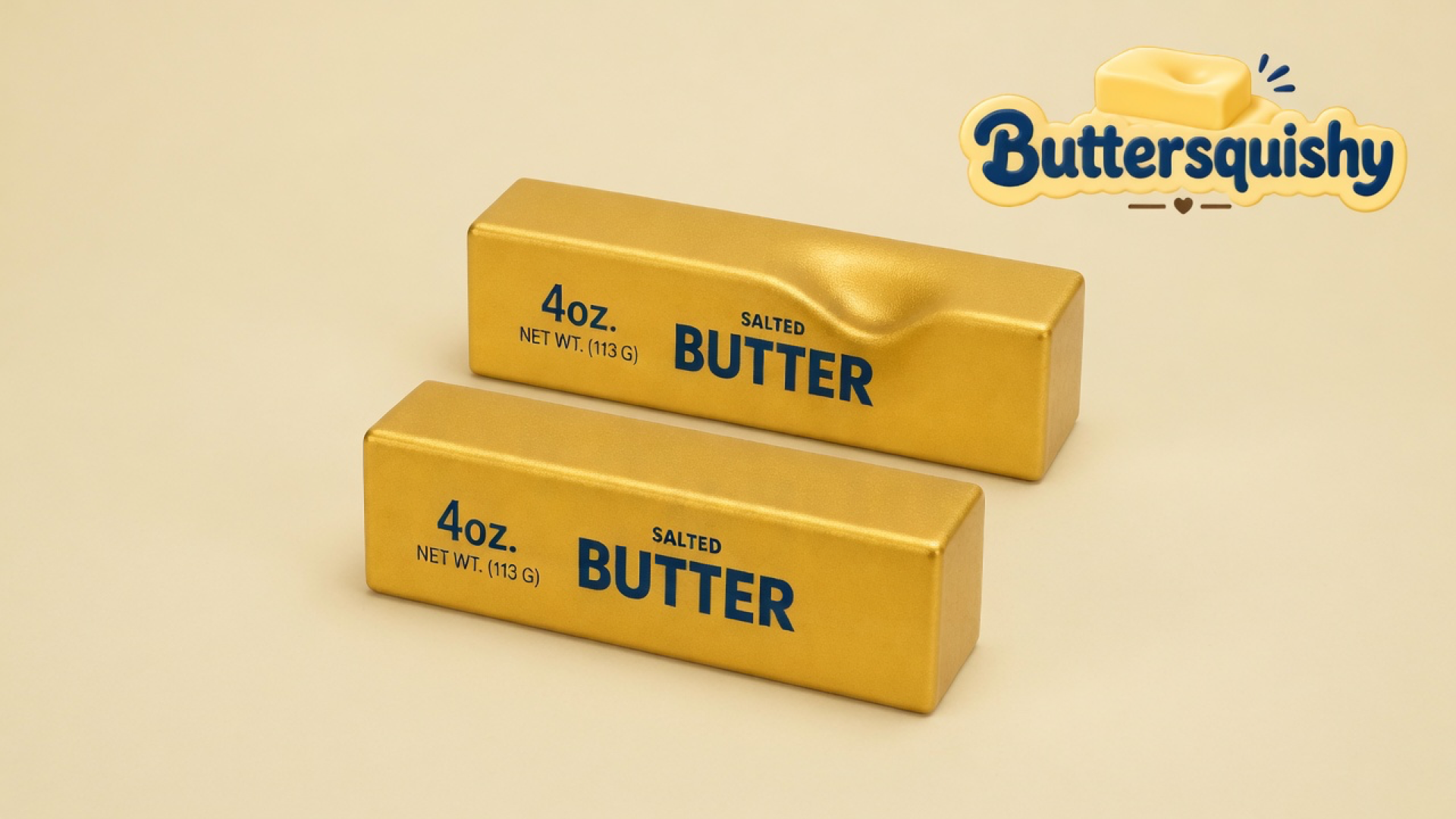 Two metallic gold-foil butter sticks printed 4oz NET WT (113 G) SALTED BUTTER on a soft light-yellow cream studio, Buttersquishy logo once at the upper right