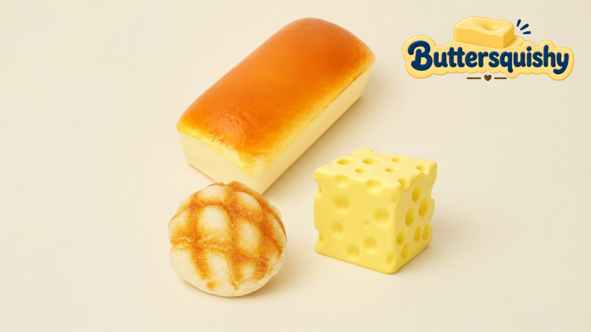 Golden bakery loaf, toasted grid bun, and yellow holey cheese cube from Cheese Cube Loaf 3-Pack on a light-yellow cream studio surface, Buttersquishy logo in the upper right