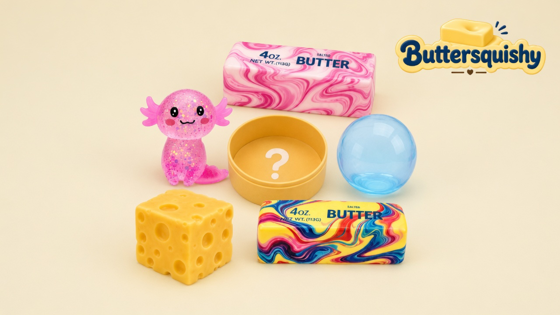 Pink glitter axolotl, two marble butter sticks, mustard question-mark cup, blue sphere, and yellow hole-face cube on a cream studio, Buttersquishy logo upper right