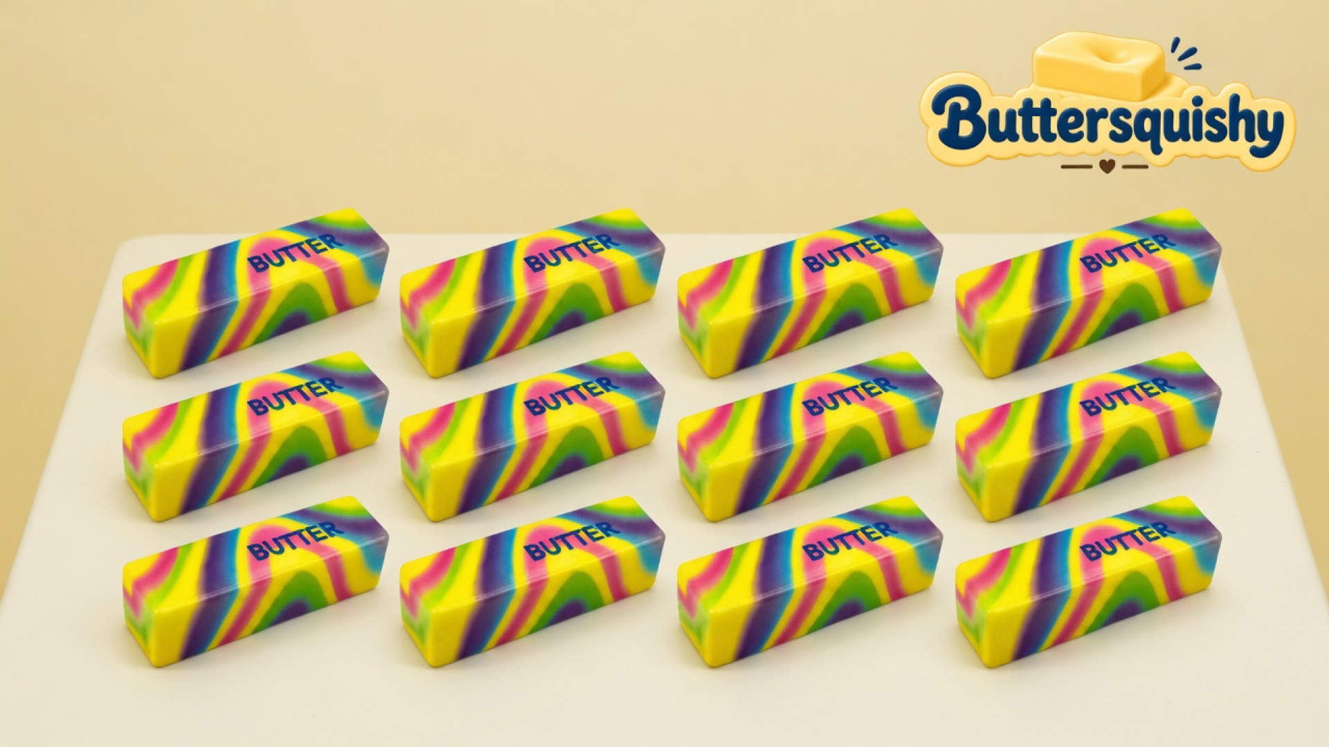 Twelve rectangular Neon Swirl Butter sticks with melted yellow-pink-purple-lime swirls and navy BUTTER print on a light-yellow cream studio table, Buttersquishy logo in the upper right