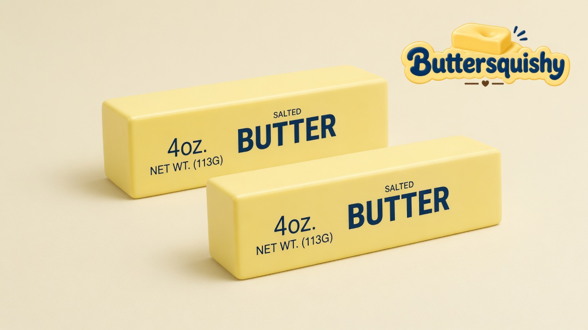 Two pale-yellow Classic Butter Stick 4oz rectangles with navy SALTED BUTTER print on a light-yellow cream studio table, Buttersquishy logo in the upper right