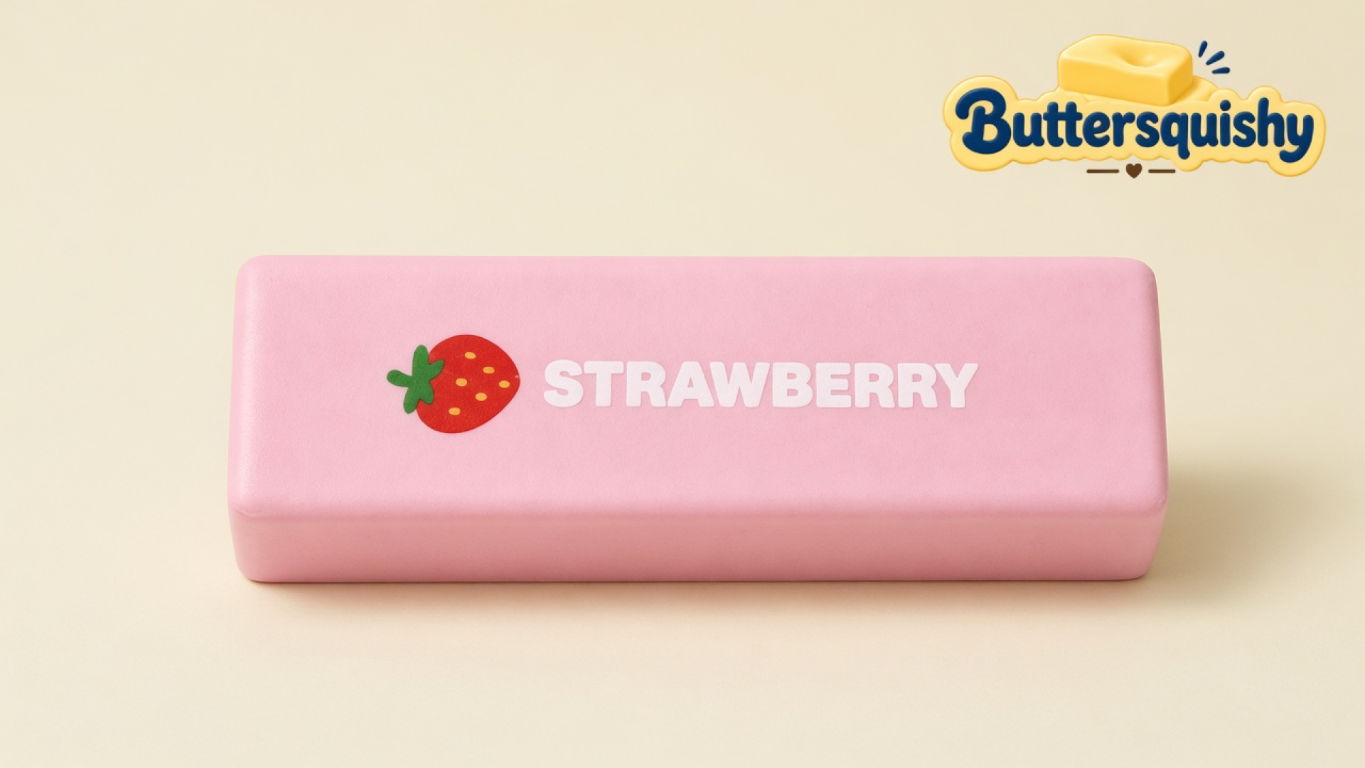 One pale pink Strawberry Butter Stick printed with a berry icon and the word STRAWBERRY on a light-yellow cream studio, Buttersquishy logo in the upper right