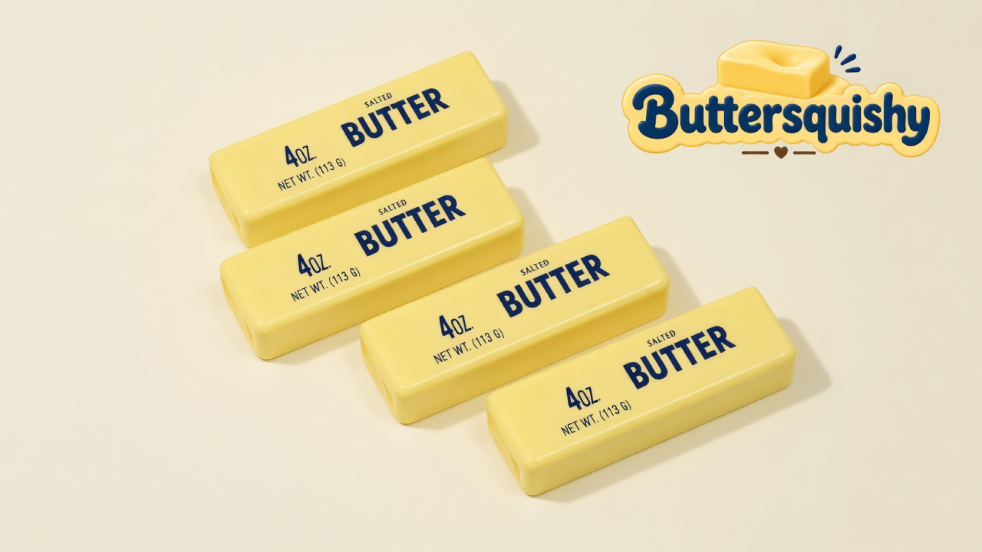 Four pale-yellow Cheese Cube Loaf 4-Pack sticks printed SALTED BUTTER on a light-yellow cream studio surface, Buttersquishy logo in the upper right