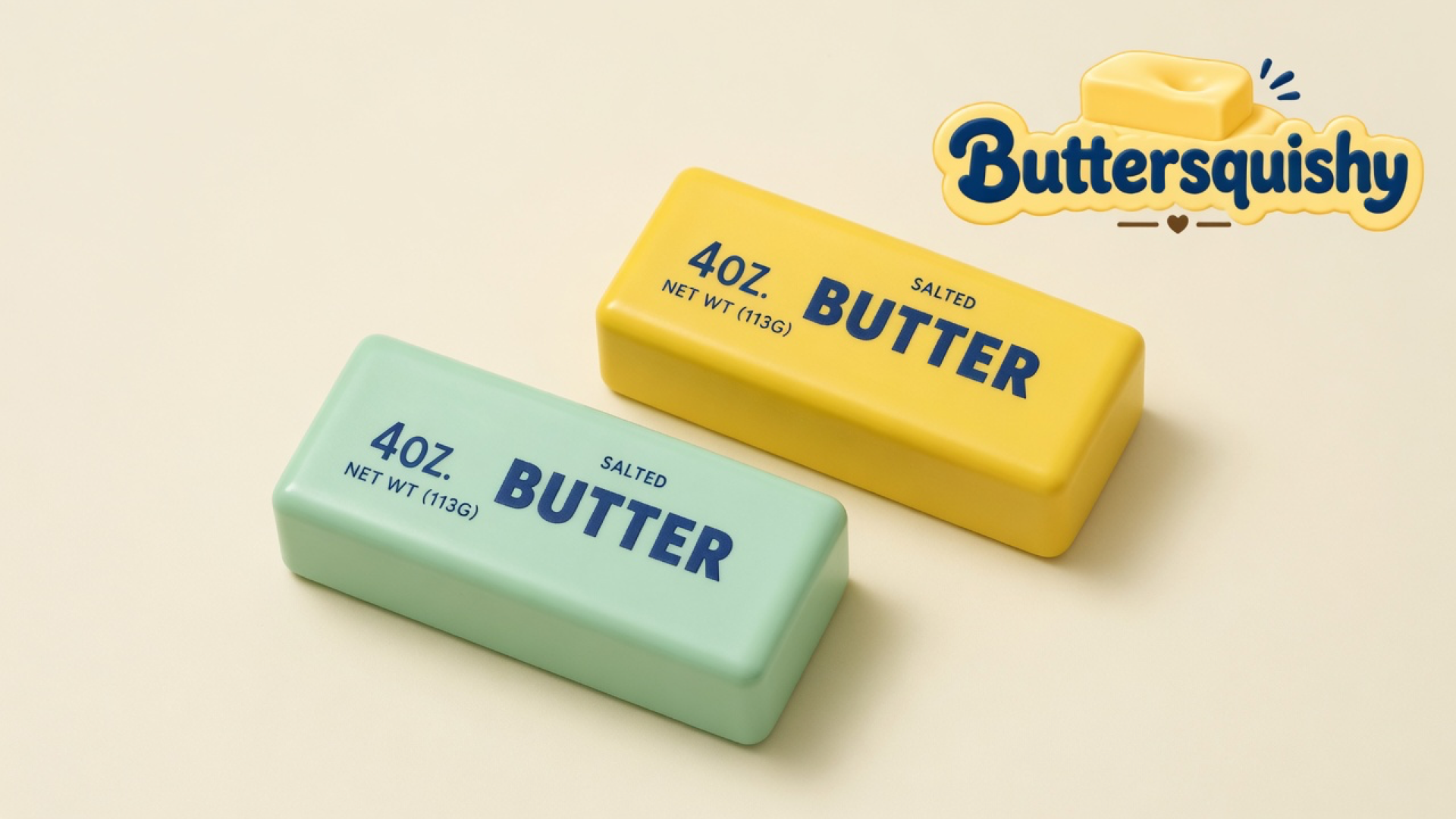 A mint-green butter loaf and a lemon-yellow butter loaf printed SALTED BUTTER on a light-yellow cream studio surface, Buttersquishy logo in the upper right