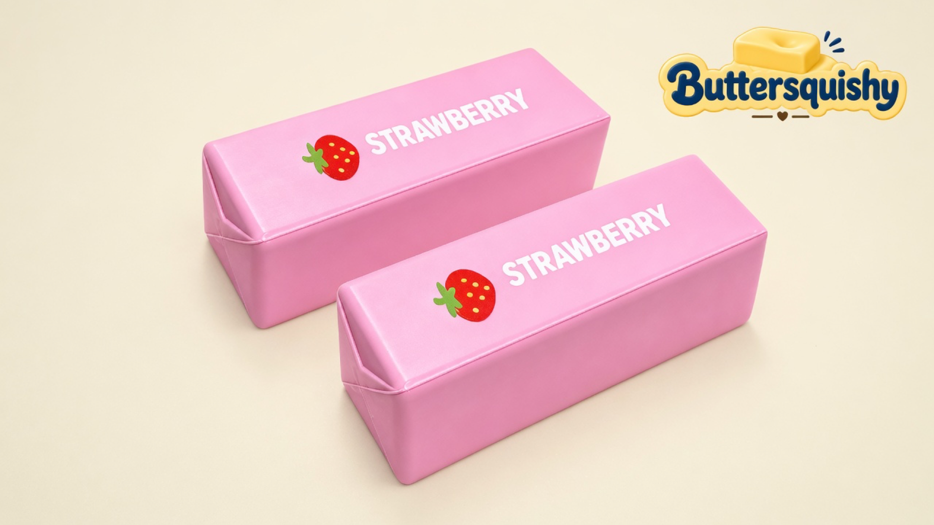 Two pale-pink butter loaves with a cartoon berry and white STRAWBERRY type, cream studio, Buttersquishy mark at top right