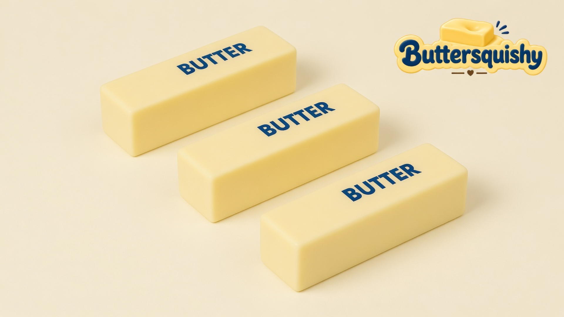 Three pale yellow Classic Butter Stick 4oz pieces printed BUTTER on a light-yellow cream studio surface, Buttersquishy logo in the upper right