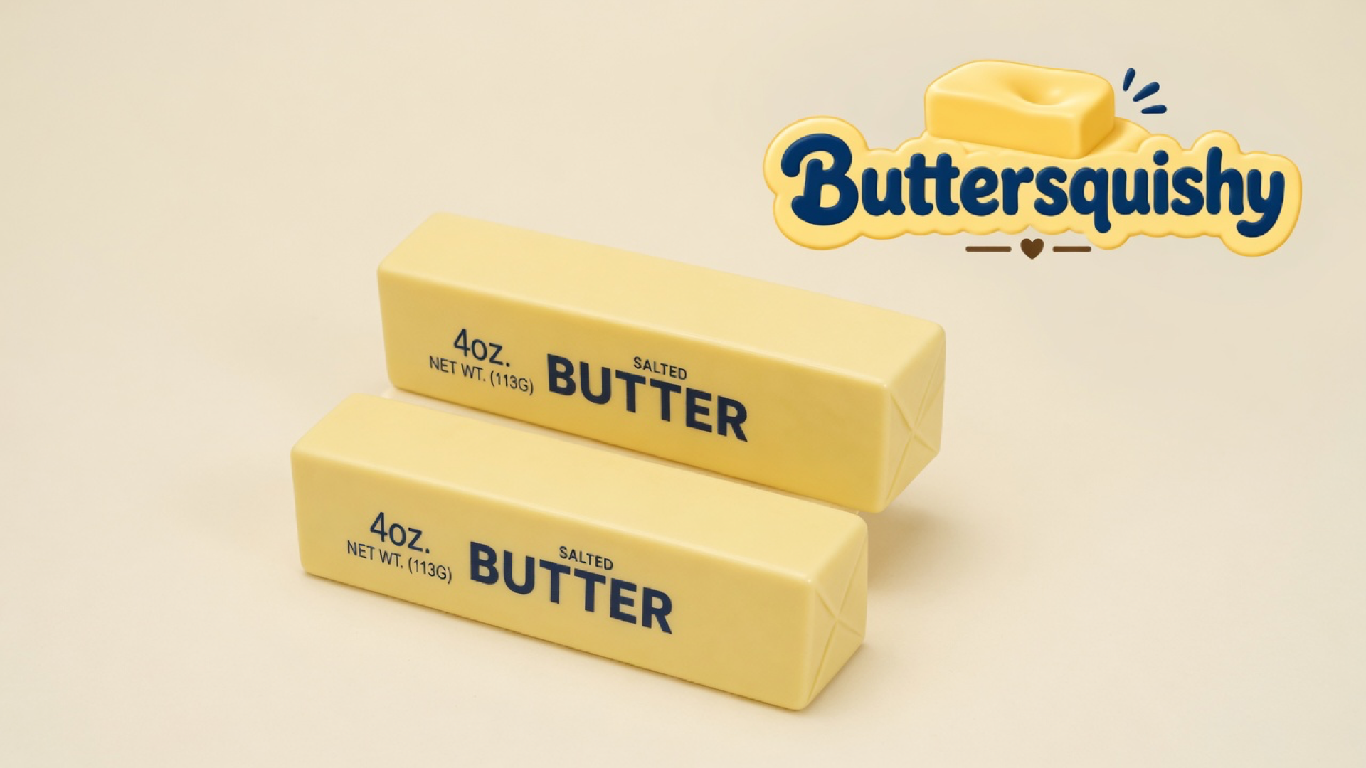 Two pale yellow SALTED BUTTER loaves on a light-yellow cream studio surface, with the Buttersquishy logo in the upper right