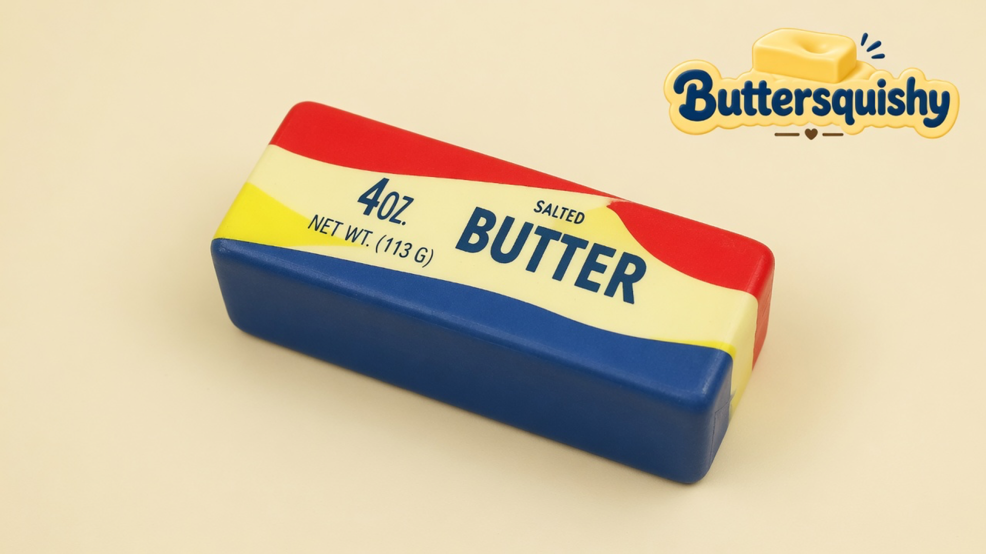 One Rainbow Stripe Butter stick with red, yellow, and blue bands on a cream studio surface, Buttersquishy logo in the upper right
