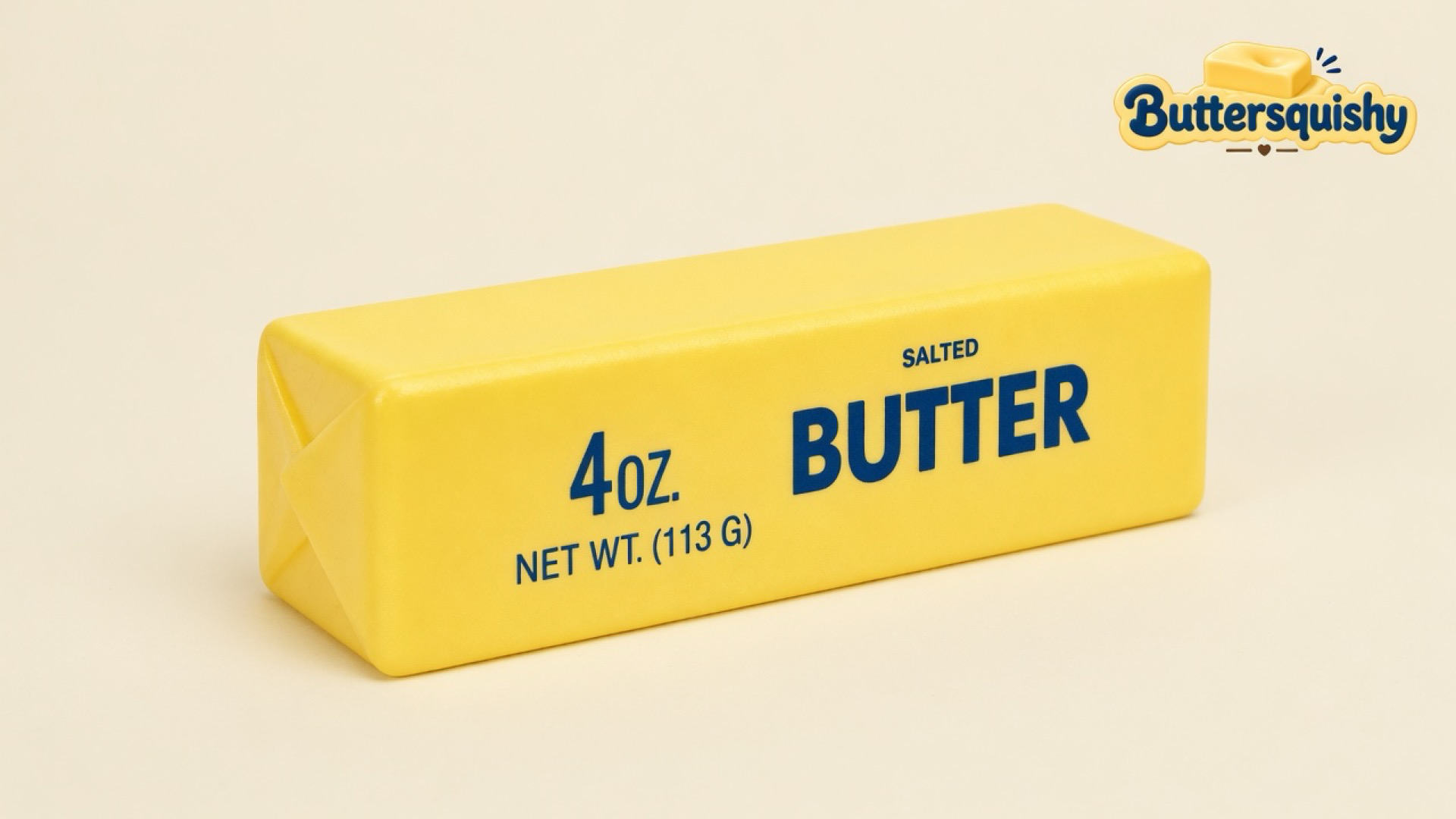 One yellow Classic Butter Stick 4oz with folded wrapper ends and navy SALTED BUTTER type on a light-yellow cream studio surface, Buttersquishy logo in the upper right