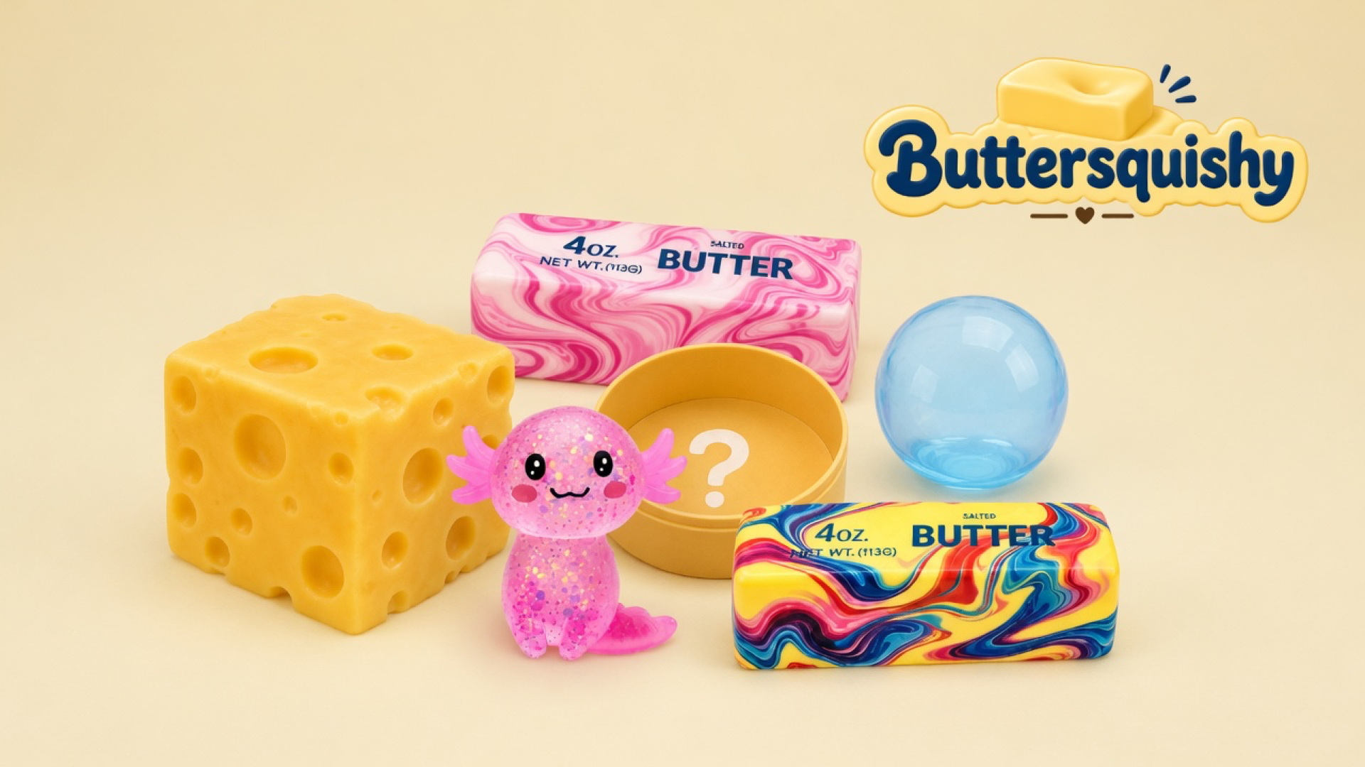 Six mixed Cheese Cube Loaf 6-Pack toys on a light-yellow cream studio surface: large yellow cheese cube, pink glitter axolotl, pink marble butter stick, yellow mystery tin, blue sphere, and rainbow swirl butter stick, Buttersquishy logo in the upper right