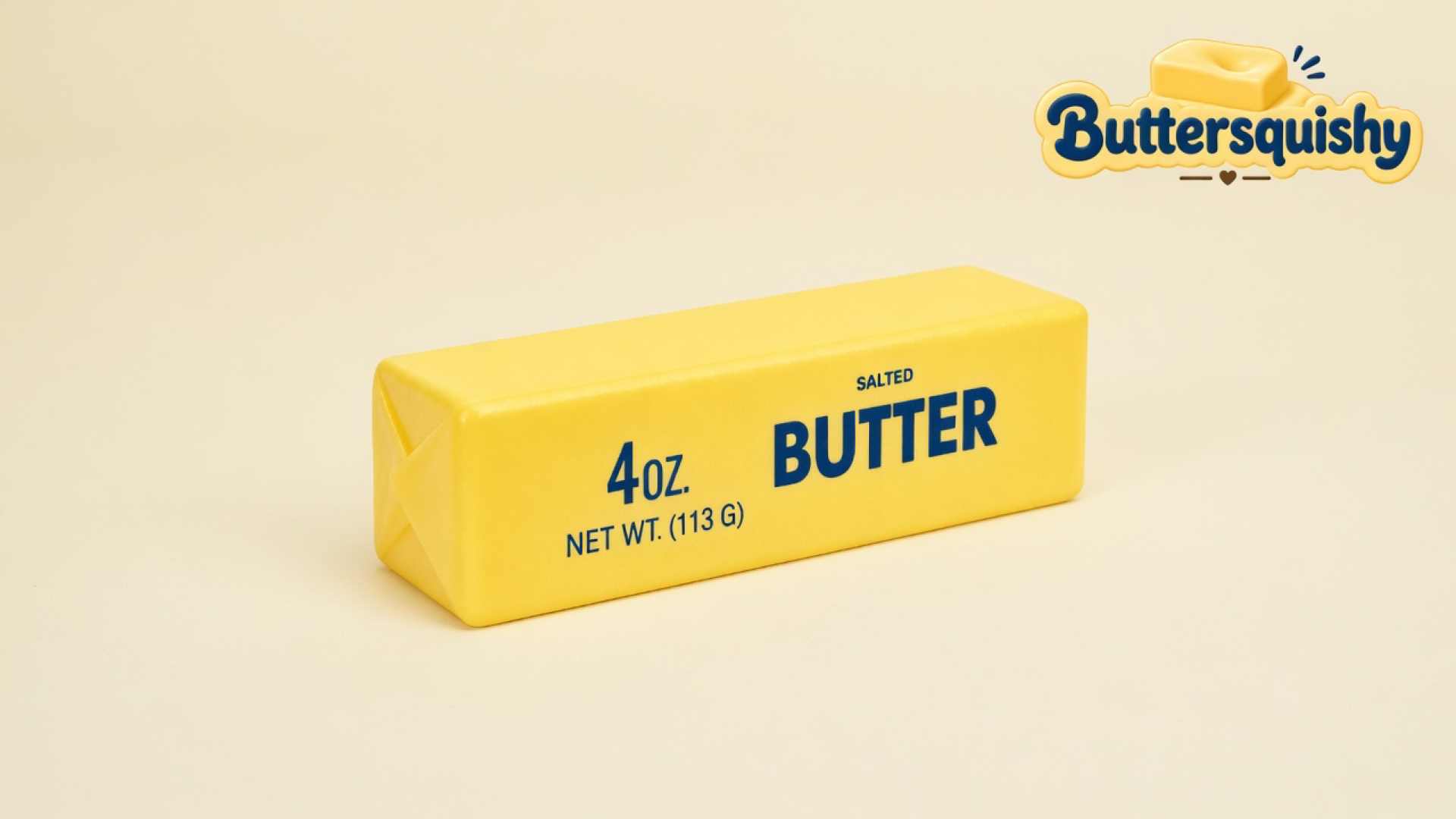 Pale yellow butter-stick squishy with navy BUTTER type on a light-yellow cream studio surface, Buttersquishy logo in the upper right